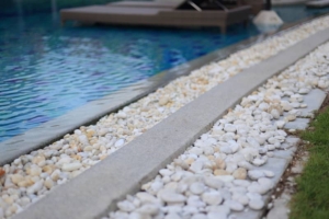white pebble stone pool deck