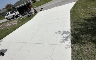 white stamped concrete driveway