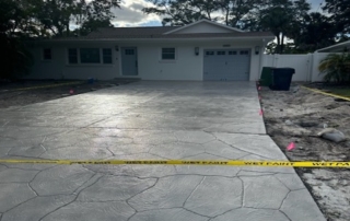 Freshly Coated Driveway Next to Renovated House