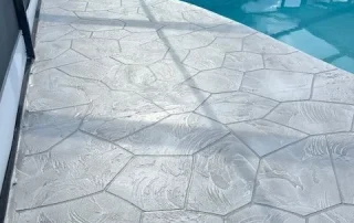 curved pool with concrete deck