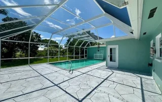 pool with white concrete deck